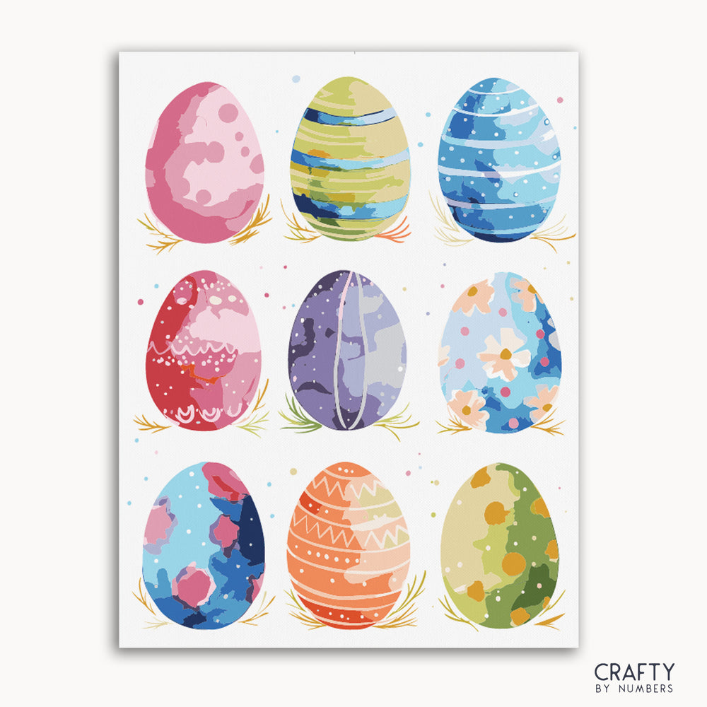 A collection of nine Easter eggs with unique watercolor-inspired designs, each in different colors and patterns, arranged on a canvas.