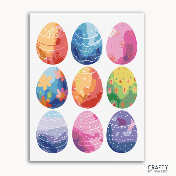 A collection of colorful Easter eggs, each with a unique design and color scheme, arranged in a grid pattern on a white background with 'Crafty by Numbers' branding in the bottom right corner.