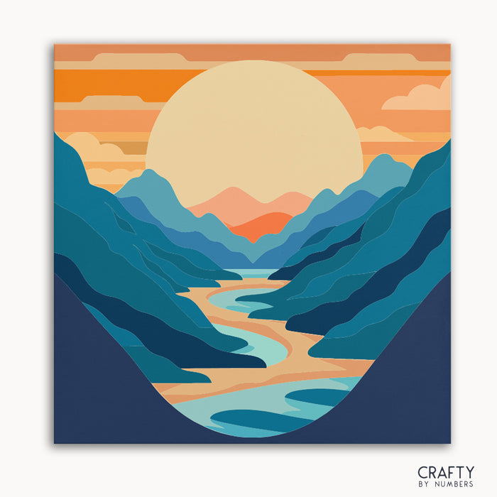 A paint-by-numbers kit depicting a mountain range with a setting sun and a winding river, with numbered areas for painting.