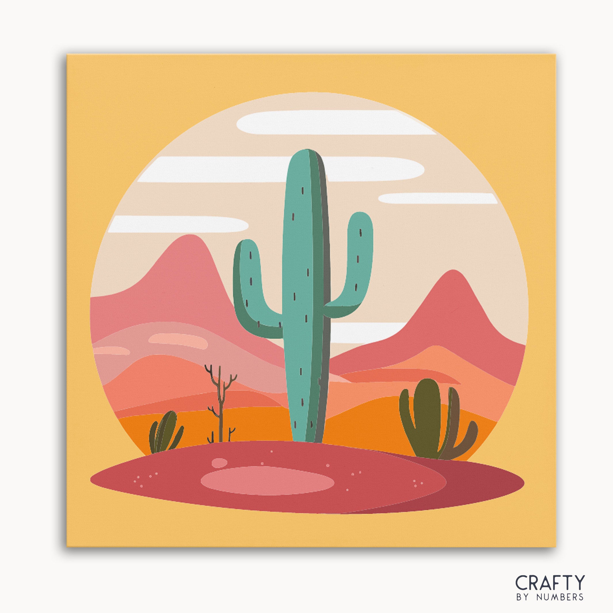 A paint by numbers kit depicting a desert scene with a tall cactus in the foreground and mountains in the background, predominantly in orange, pink, and green colors.