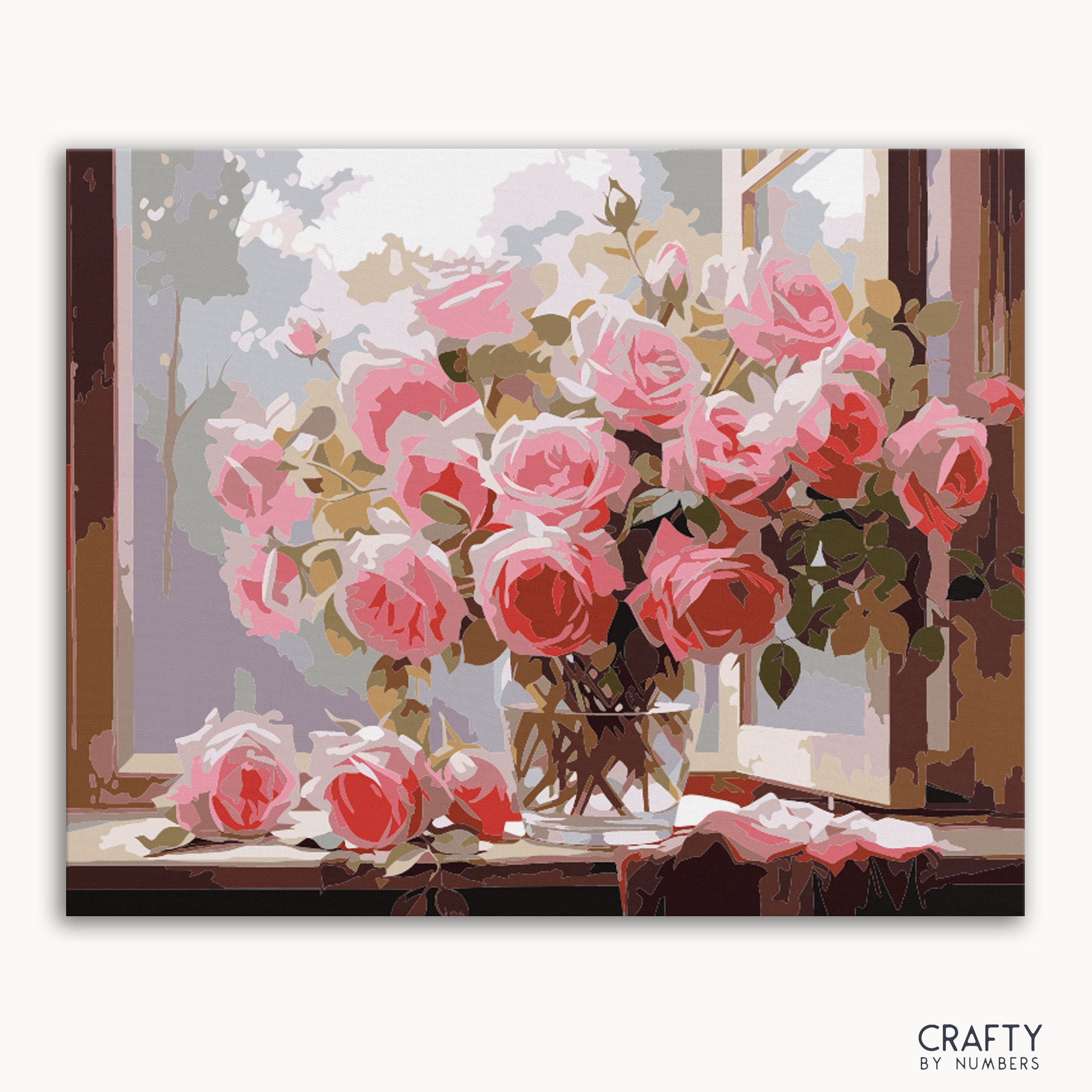 A paint by numbers kit depicting a vase of pink roses placed on a windowsill, with the brand 'Crafty By Numbers' visible on the bottom right.