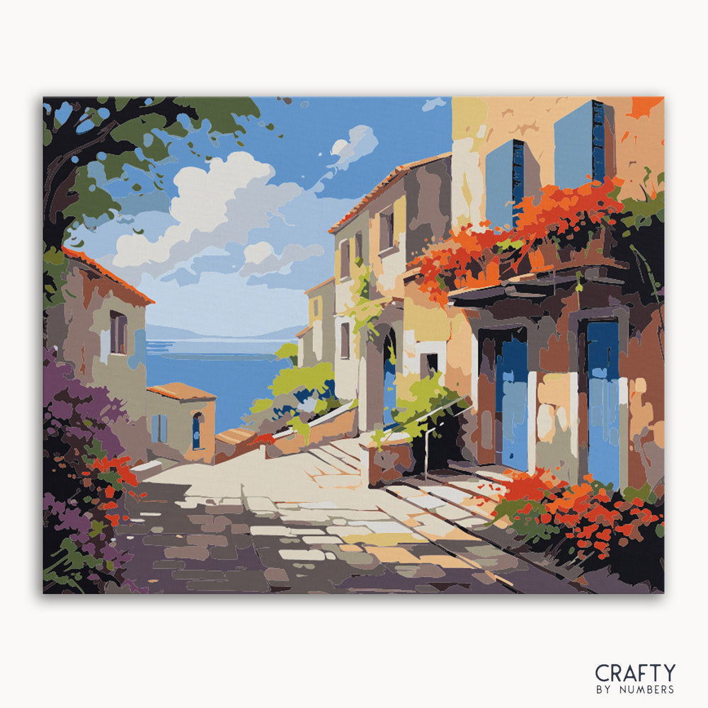 A paint by numbers kit depicting a vibrant coastal village scene with Mediterranean architecture, blooming flowers, and a sun-drenched cobblestone path.