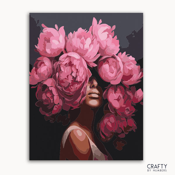 A paint by numbers kit depicting a portrait of a woman with a peony flower design.