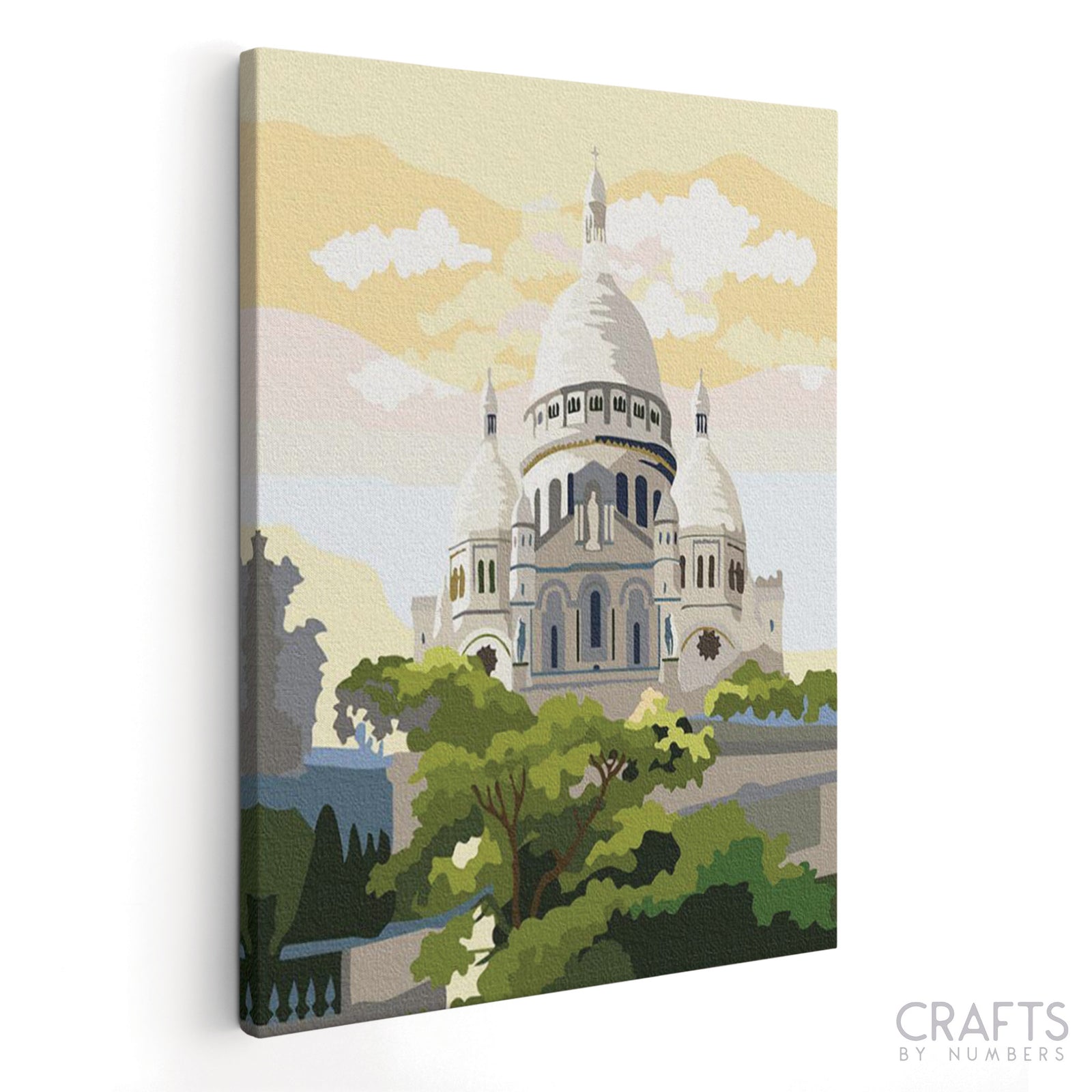 Ein Malset, das die Basilika Sacre Coeur mit einer Leinwand vor einem weißen Hintergrund darstellt.