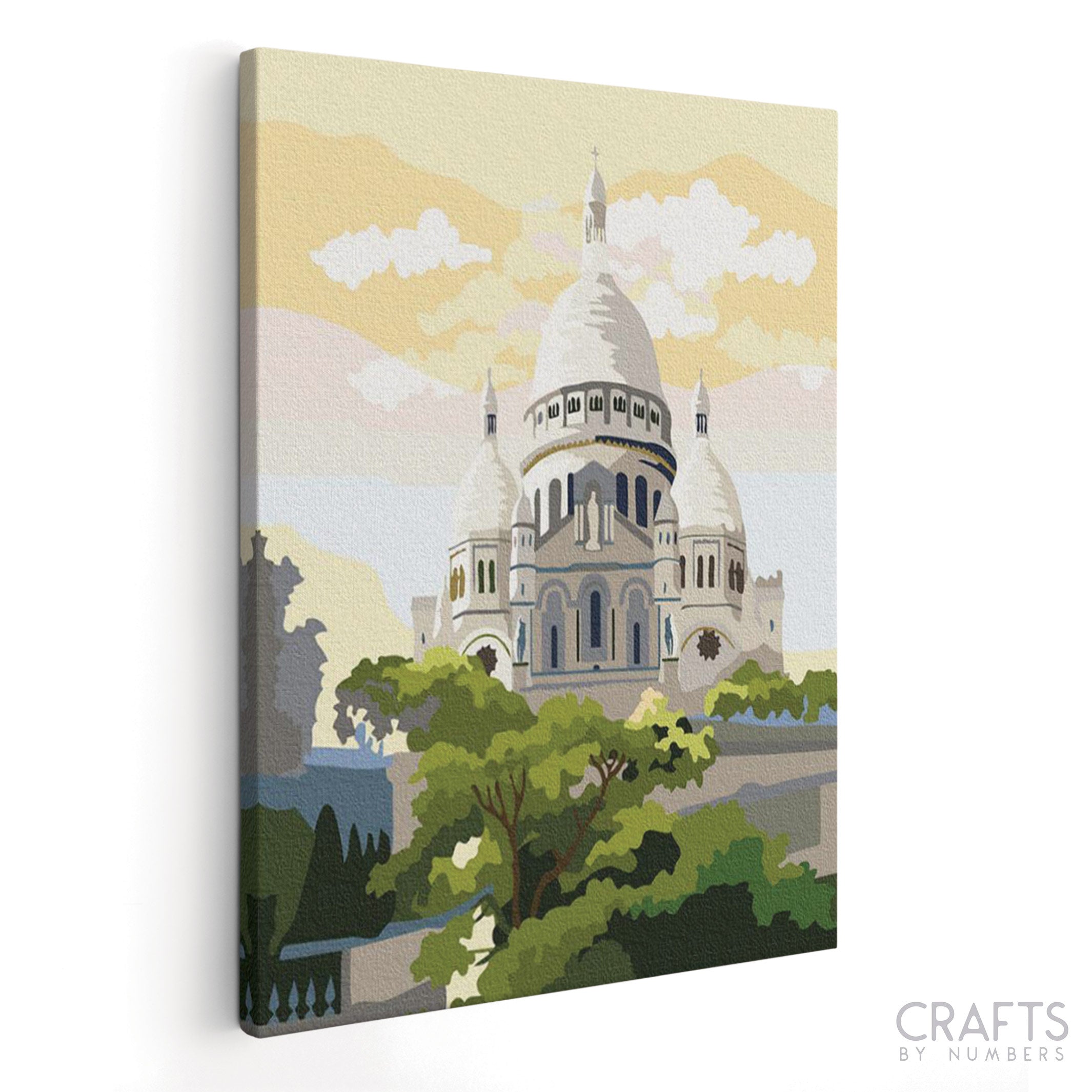 A painting kit depicting the Sacre Coeur Basilica with a canvas placed against a white background.