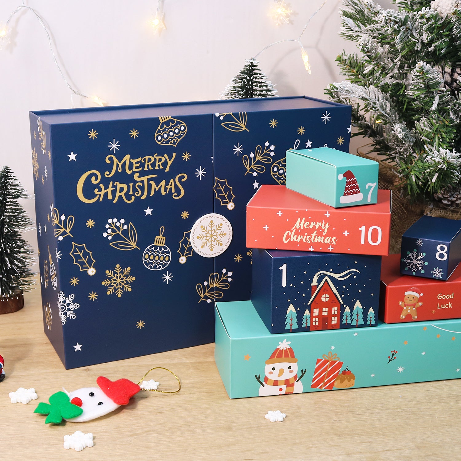 Advent calendar with numbered boxes on a wooden surface, Christmas tree in the background