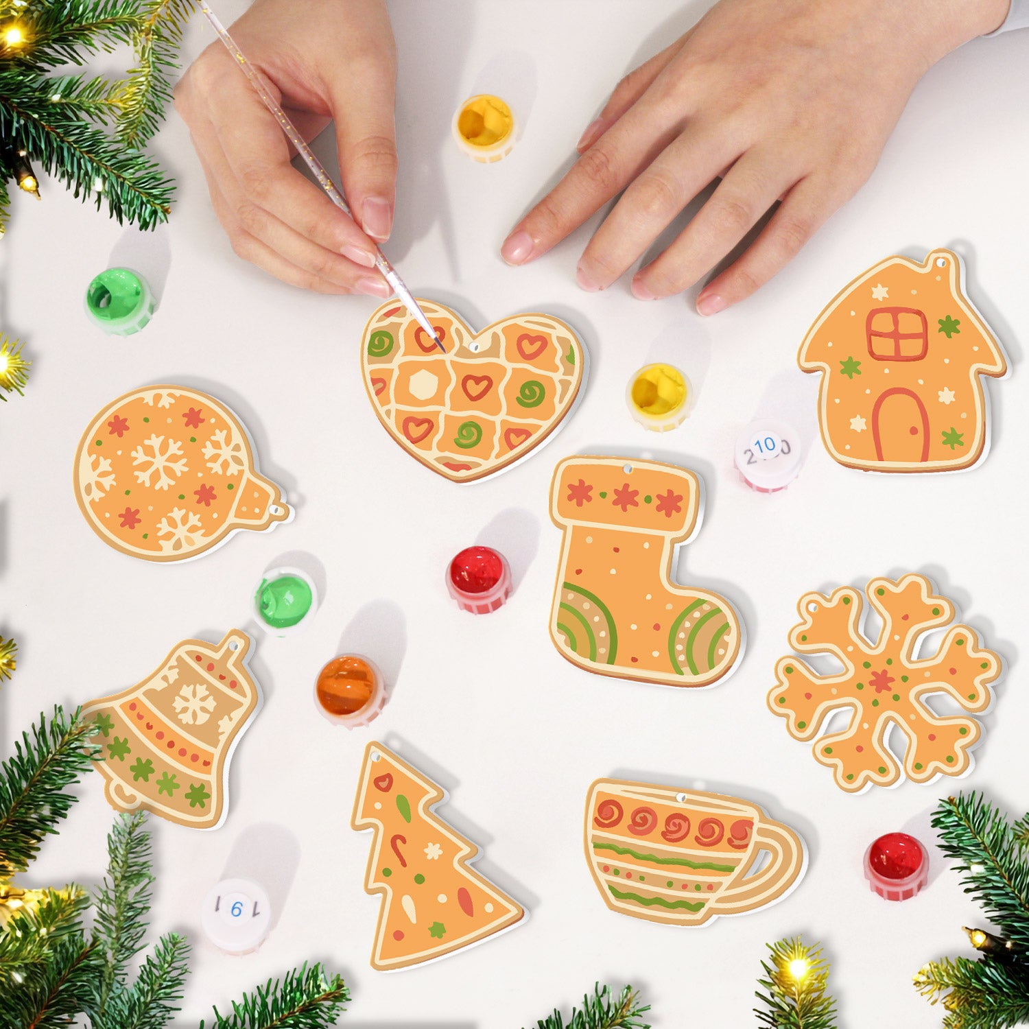Decorative Christmas cookies shaped like a heart, house, bell, sock, tree, and snowflake with icing on a white surface.