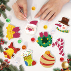 Children's hands painting Christmas-themed ceramic decorations on a white surface with festive elements.