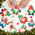 Colorful gnome decorations on a white surface with Christmas lights and greenery.