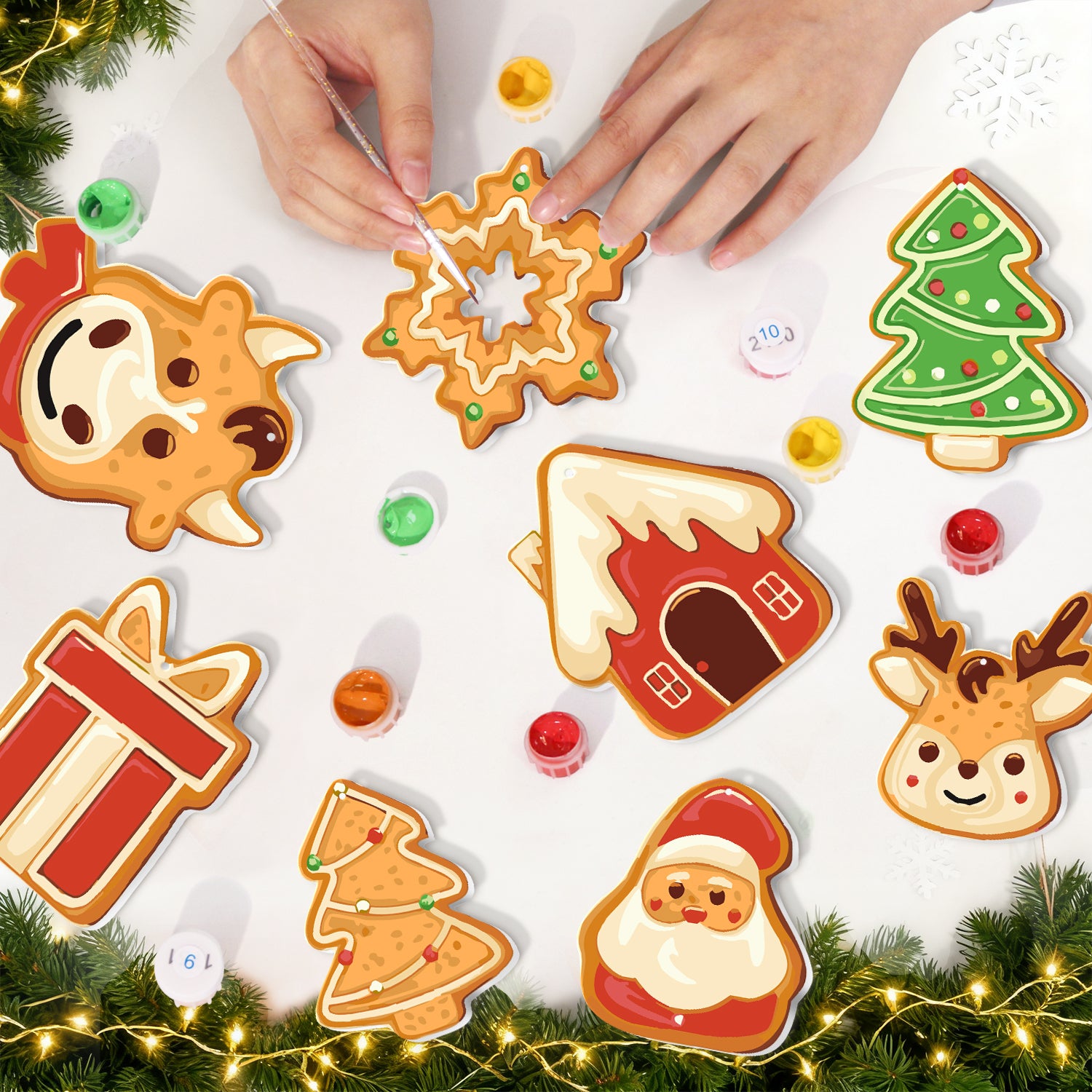 Decorative cookies shaped like a snowflake, house, gift, tree, and reindeer on a white surface with Christmas decorations.