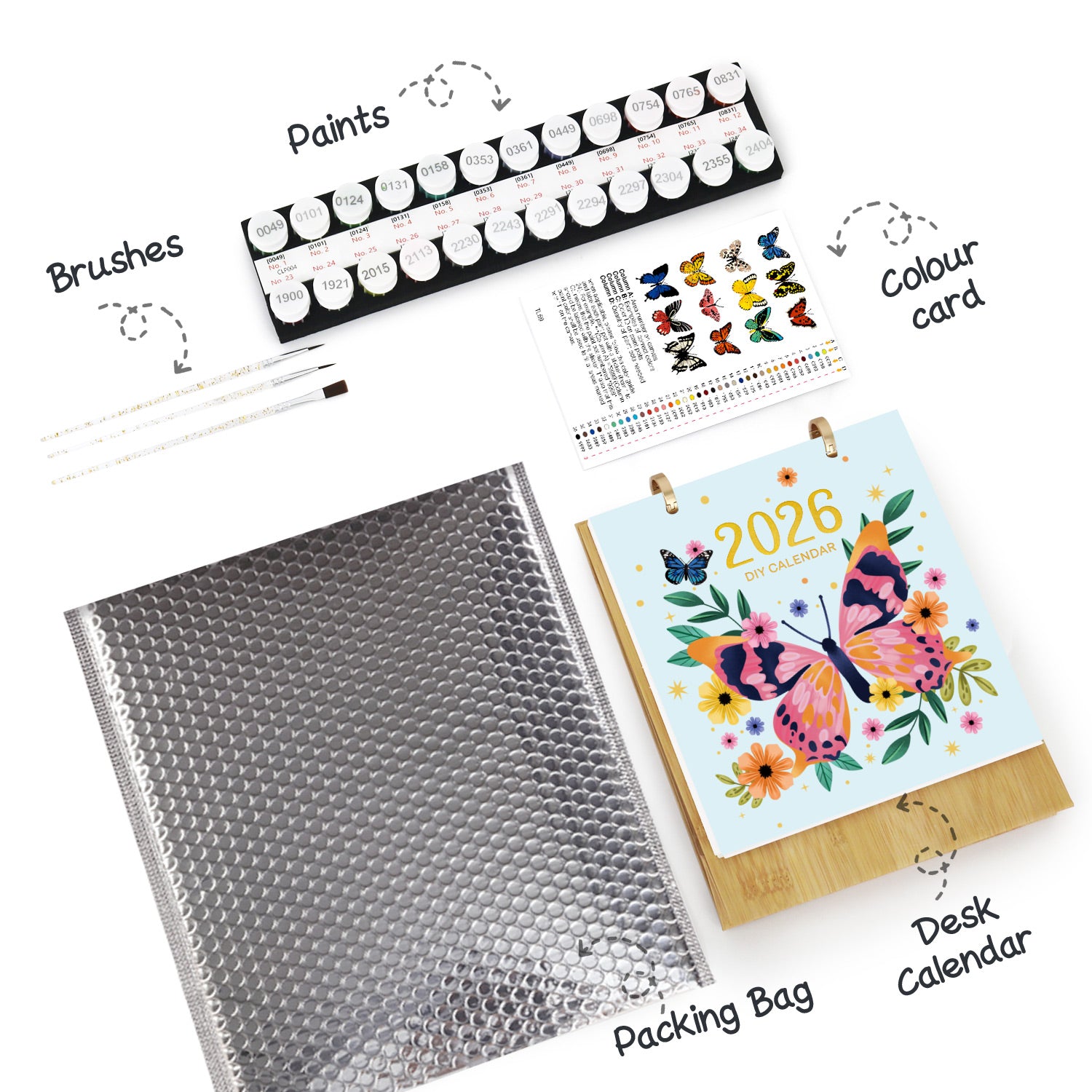Artistic supplies including paints, brushes, a color card, and a desk calendar with butterflies on a white background.