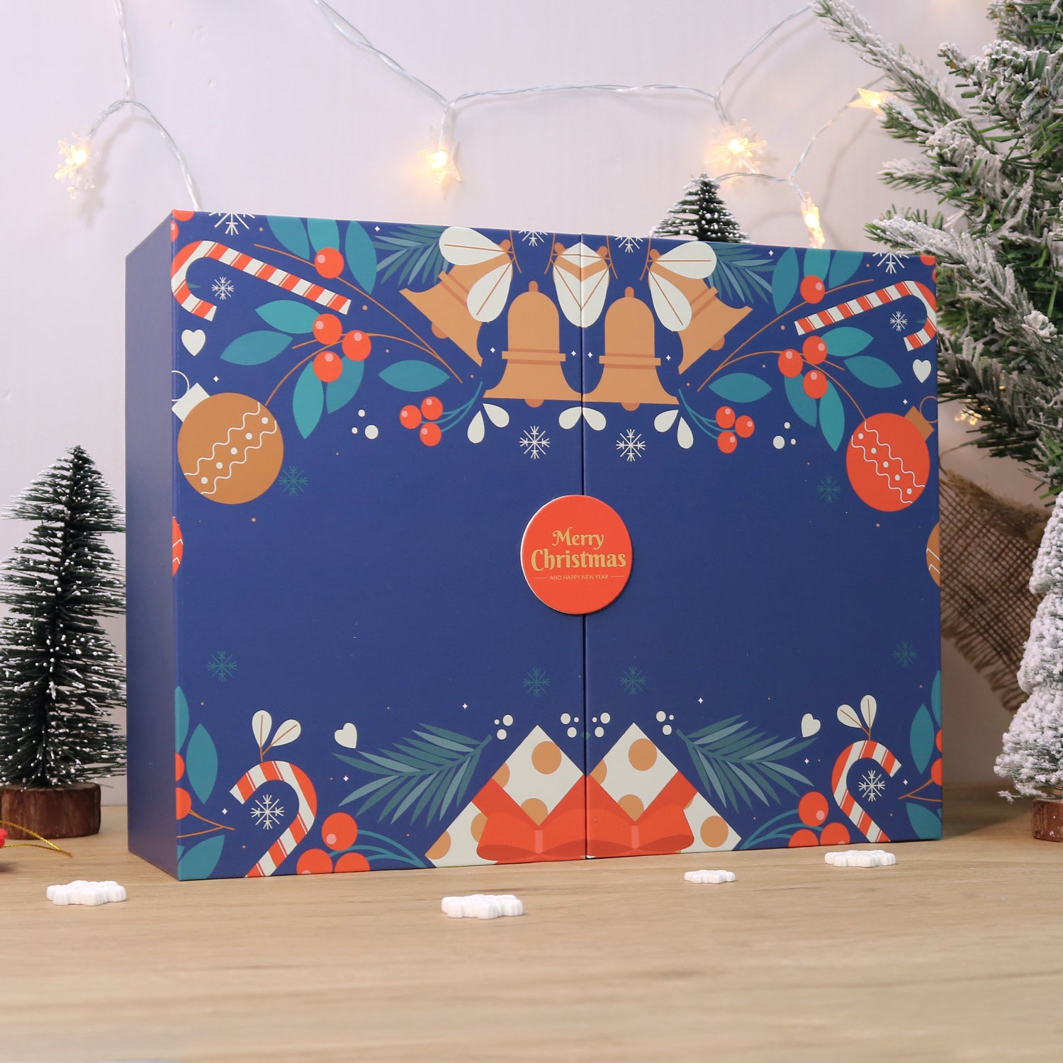 Decorative Christmas box with festive design on a wooden surface.