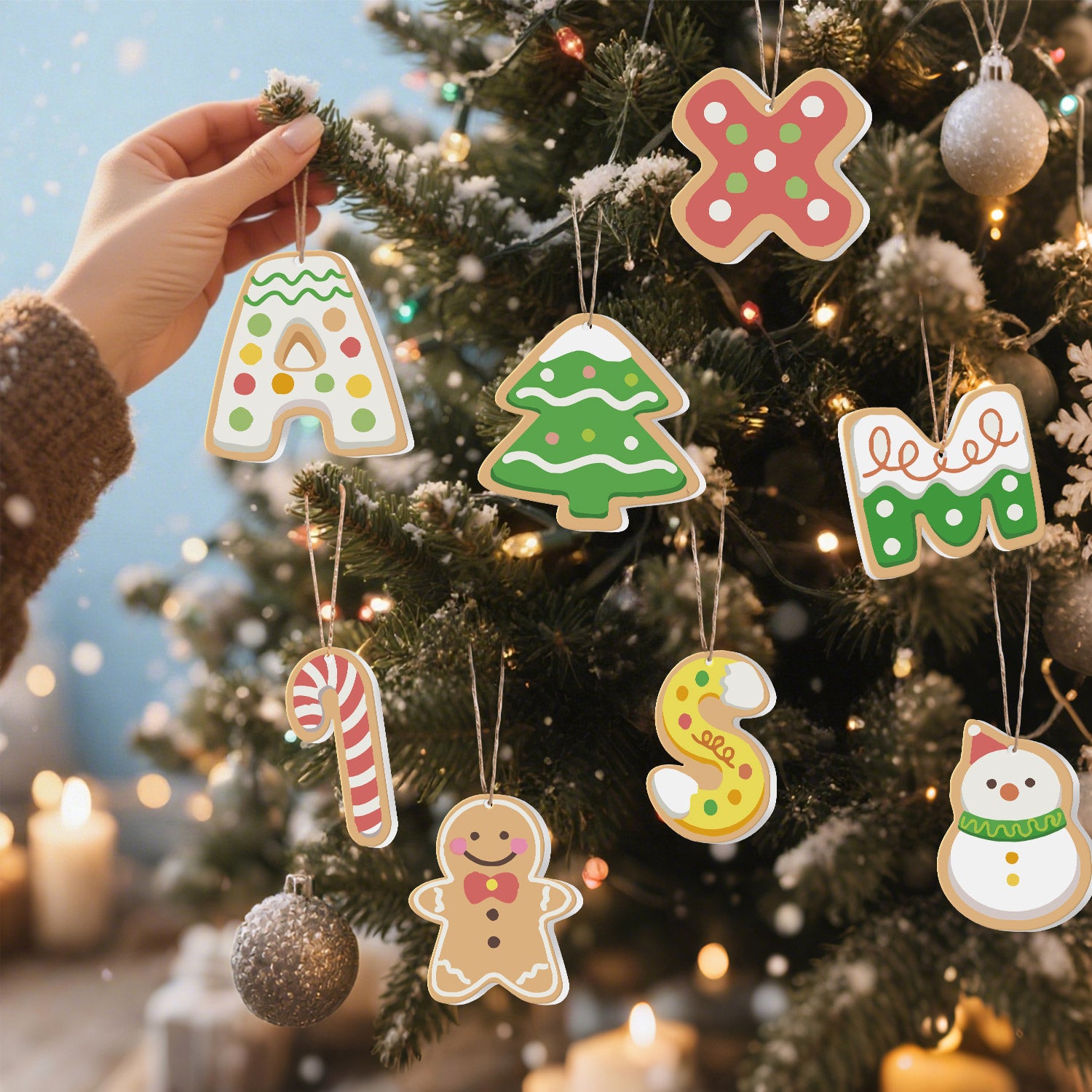 Hand holding a letter 'A' ornament with a Christmas tree and other ornaments in the background.