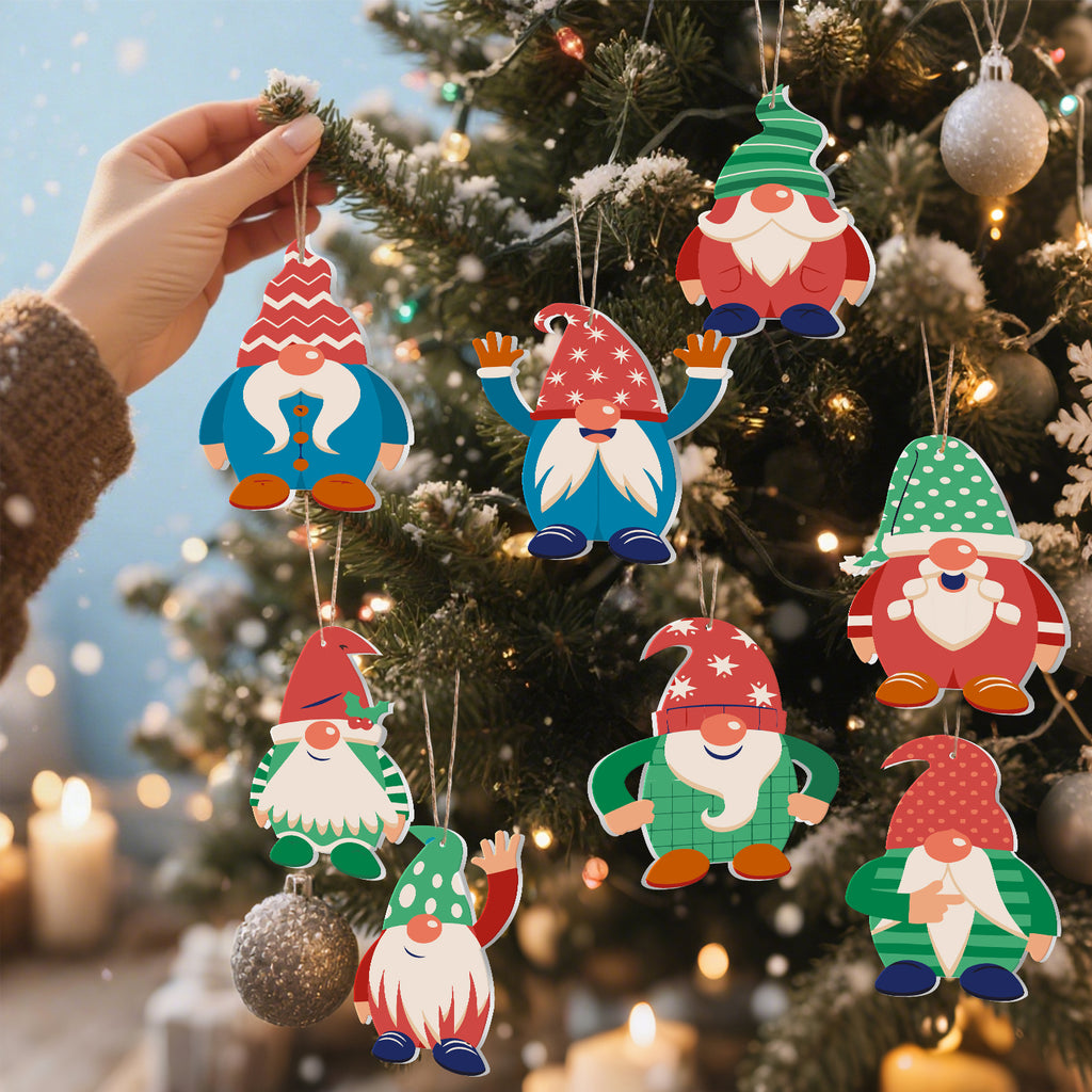Hand holding a set of gnome-shaped Christmas ornaments against a decorated tree.