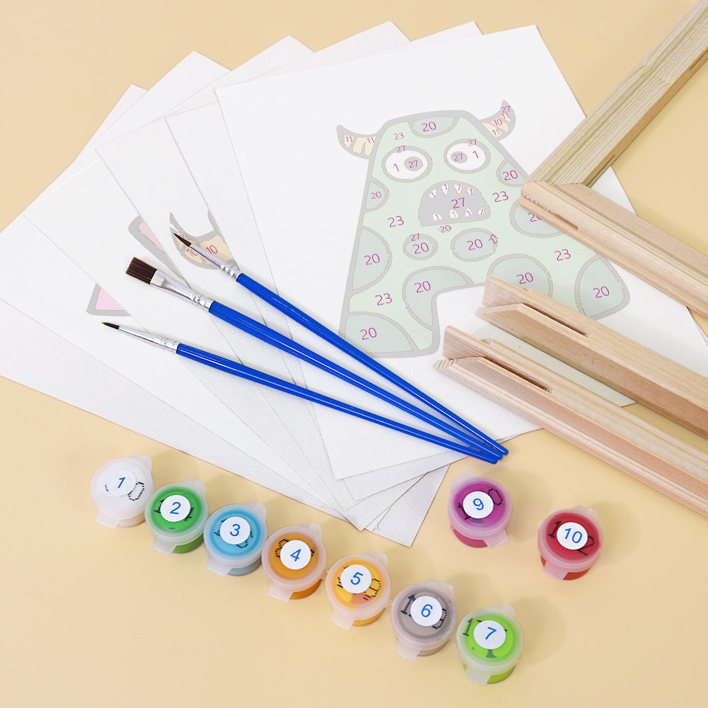 Art supplies including paintbrushes, color swatches, and a small easel on a beige surface.