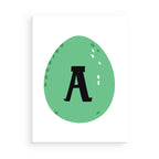 Green Easter egg with a black letter 'A' on a white background