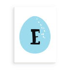 Blue Easter egg with the letter 'E' on a white background