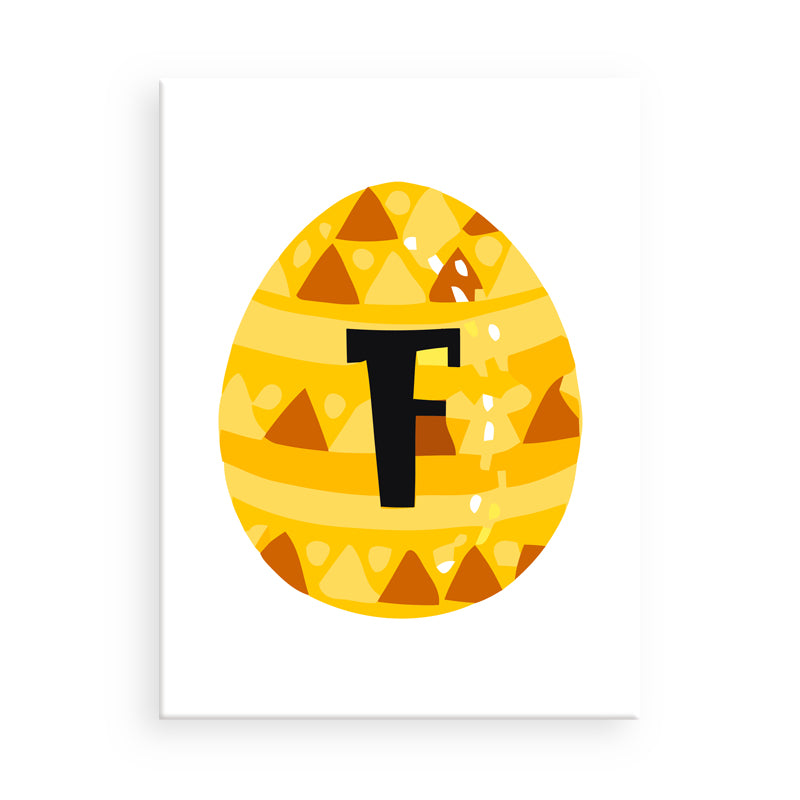 Yellow Easter egg with a pattern and letter 'F' on a white background