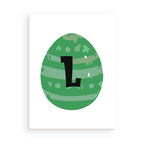 Green egg-shaped object with a black letter 'L' on a white background