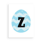 Easter egg with blue and white zigzag pattern and black letter 'Z' on a white background