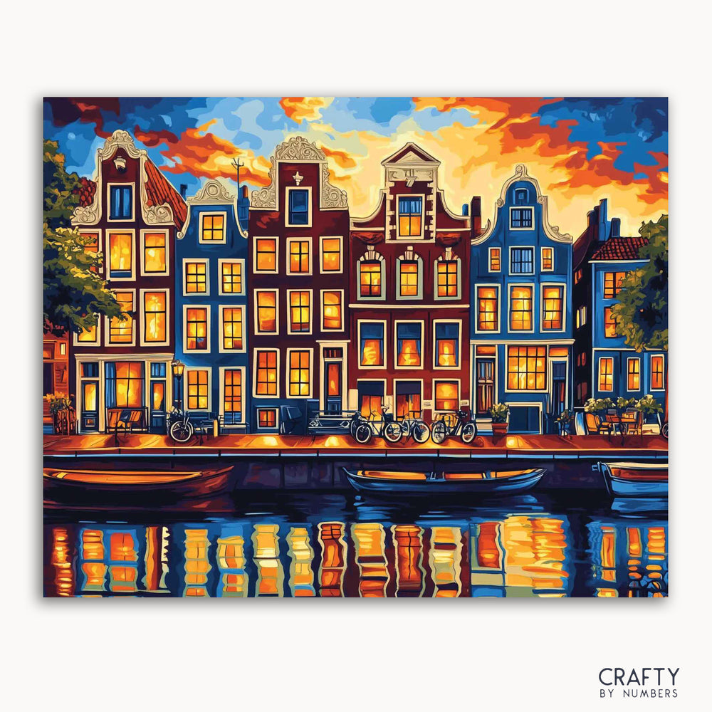 A paint-by-numbers kit depicting the iconic canal houses of Amsterdam illuminated at twilight with a reflection in the water.