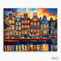 A paint-by-numbers kit depicting the iconic canal houses of Amsterdam illuminated at twilight with a reflection in the water.