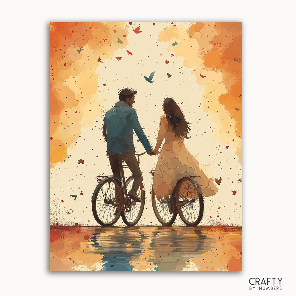 A paint-by-numbers kit depicting a couple riding a bicycle in autumn with leaves scattered around, titled 'Autumnal Ride'.