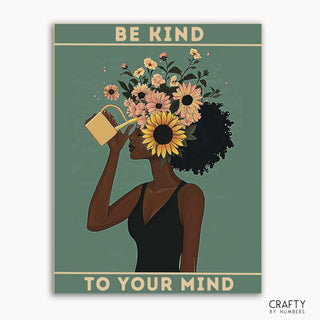 Ein Malen-nach-Zahlen-Set, das eine Frau mit Sonnenblumen und Wildblumen im Haar zeigt, mit dem Text „BE KIND TO YOUR MIND“ auf blauem Hintergrund.