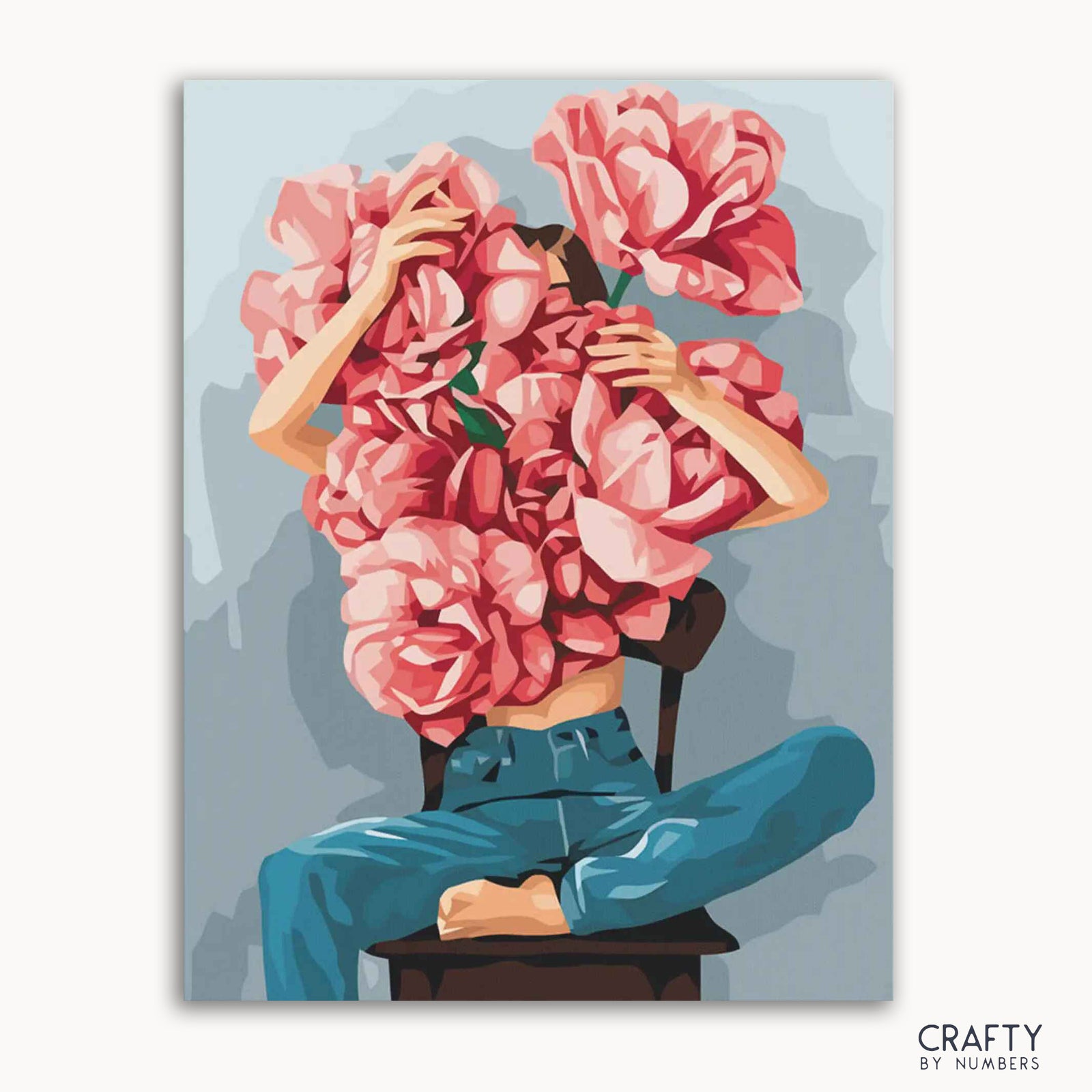 Imagen de un kit de pintura por números que muestra a una persona con un diseño floral que cubre su cabeza y parte superior del cuerpo, sentada en una silla, con la marca 'CRAFTY by NUMBERS' visible.