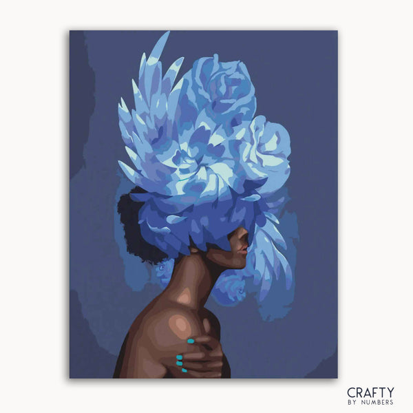 A paint-by-numbers kit depicting a figure with a blue floral arrangement as a hat, with segments marked for painting.