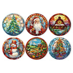 A set of six round placemats with different Christmas-themed designs including Santa, Christmas trees, and snowmen, all illustrated in a colorful, stained-glass style.