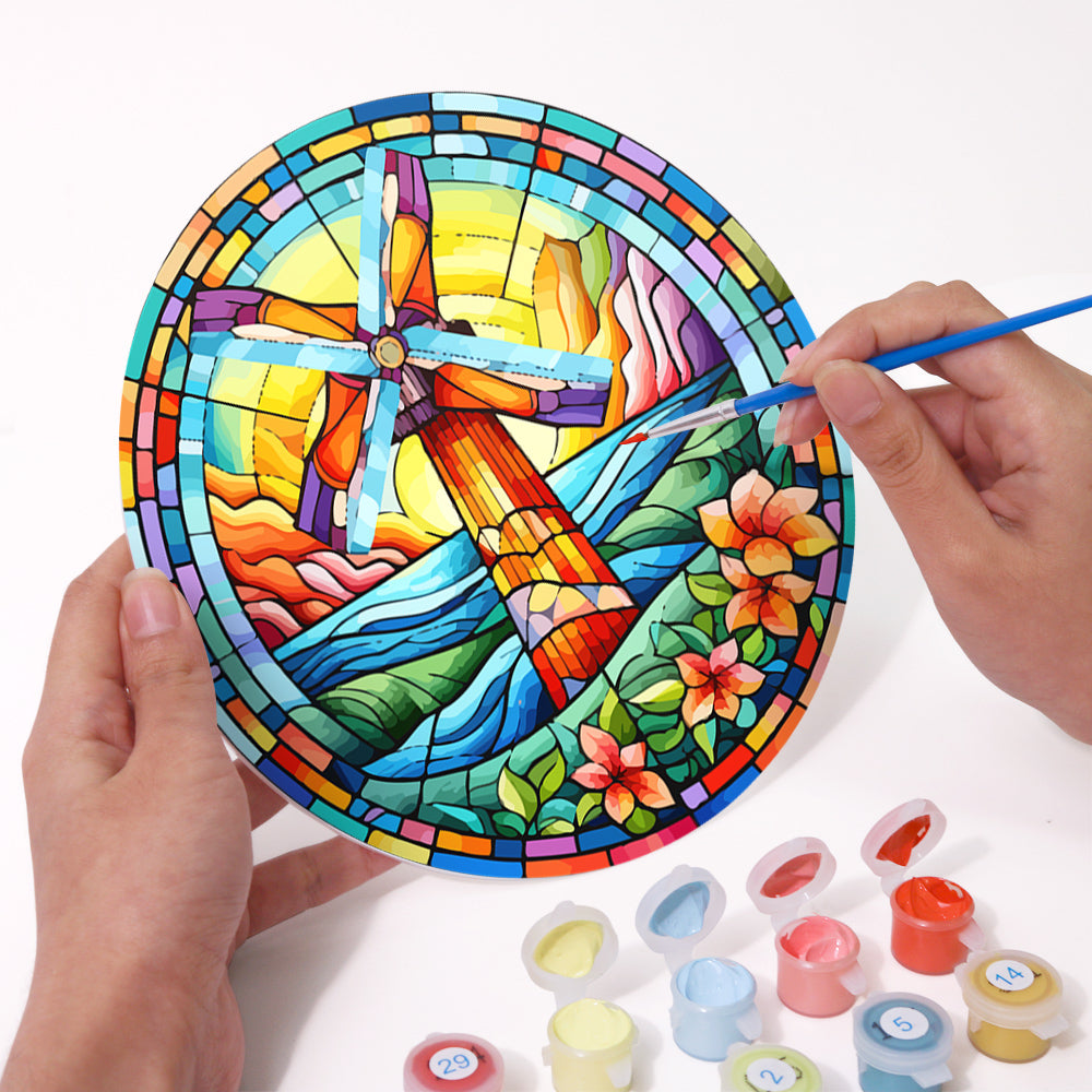 Stained glass style paint by numbers kit with bright glowing light designs.