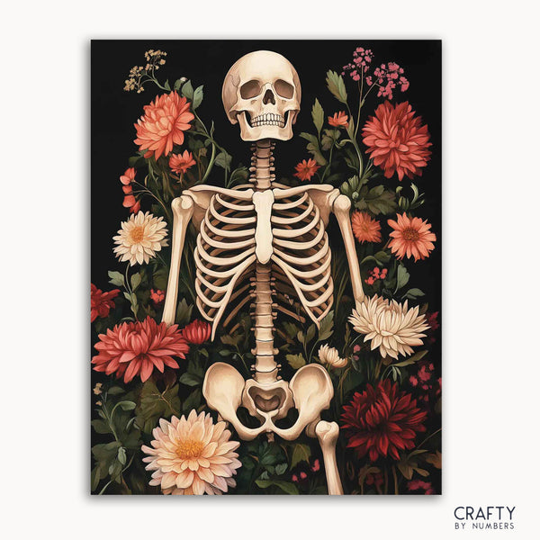 A paint by numbers kit with a design of a skeleton amidst a floral backdrop, with the brand name 'Crafty by Numbers' visible.