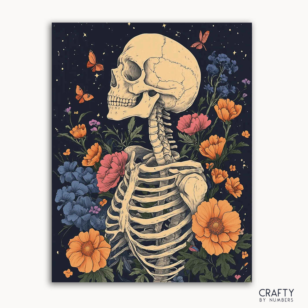 A paint by numbers kit featuring a skeleton with flowers and butterflies, with the brand 'Crafty by Numbers' visible.