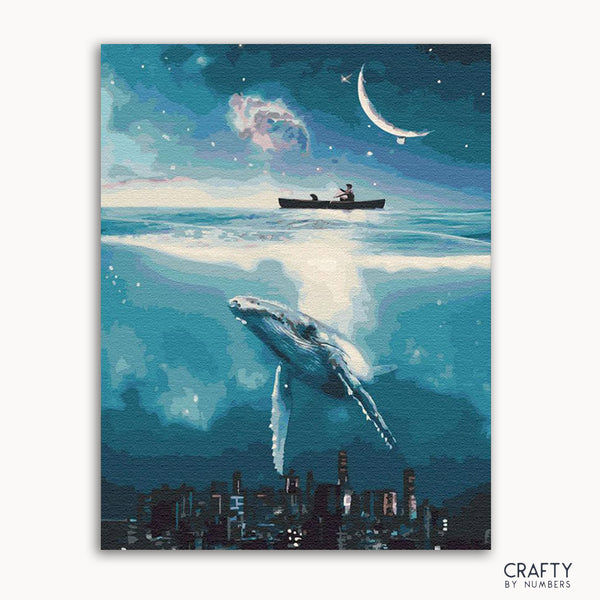 A framed painting depicting a whimsical night scene with a cityscape, a boat, a large fish, and a crescent moon in the sky.