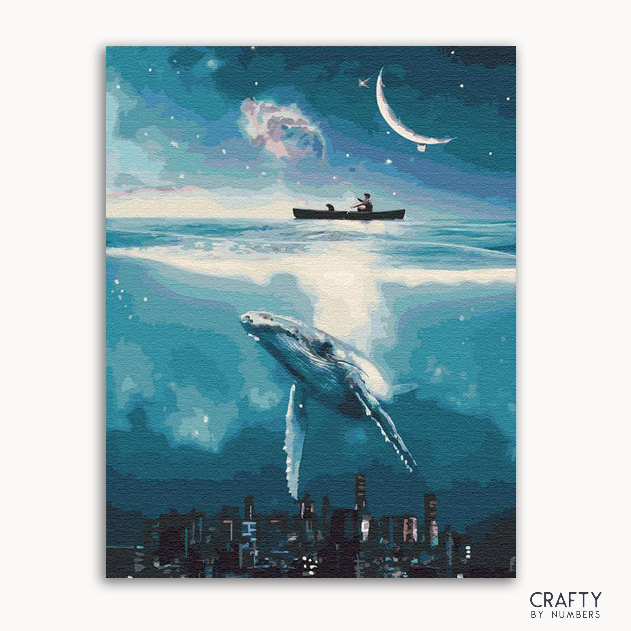 A framed painting depicting a whimsical night scene with a cityscape, a boat, a large fish, and a crescent moon in the sky.