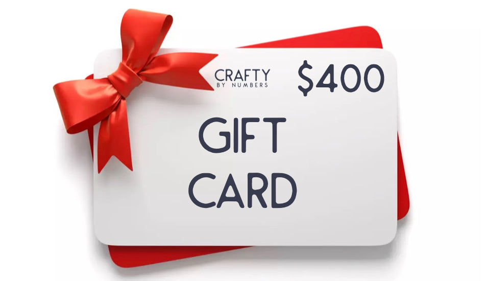 A white gift card with the words 'GIFT CARD' printed in bold letters, tied with a red ribbon.