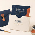Gift card holder with 'Crafty by Numbers' branding on a light background