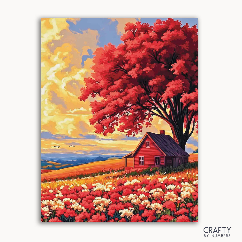A paint-by-numbers kit depicting a cozy cottage under a large red tree with a golden hour sunset in the background, surrounded by a field with flowers.