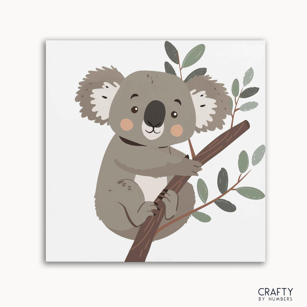 A paint-by-numbers kit depicting a cute koala sitting on a tree branch with leaves.