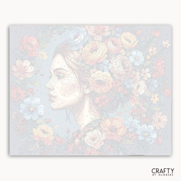 Artistic depiction of a woman's profile surrounded by flowers on a light blue background with 'Crafty by Numbers' branding.