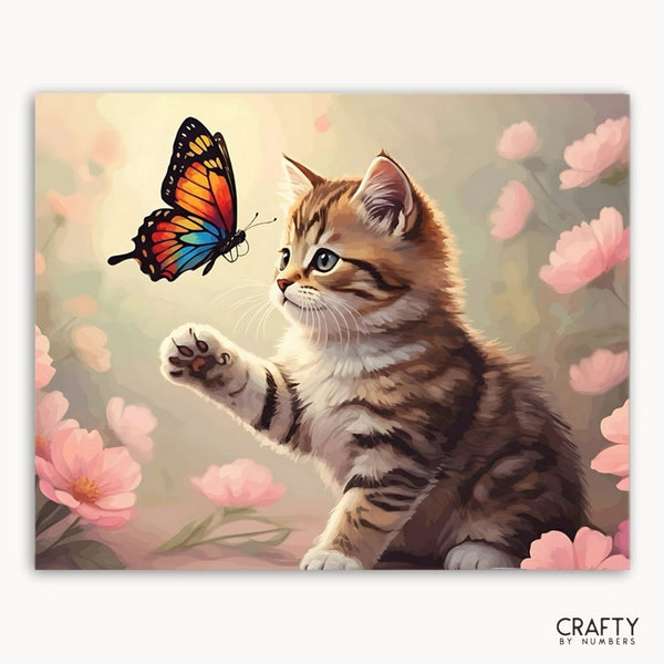 Painting of a kitten reaching out to a butterfly among flowers