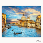 Venice cityscape with gondolas on the Grand Canal at sunset, featuring the Basilica di Santa Maria della Salute.