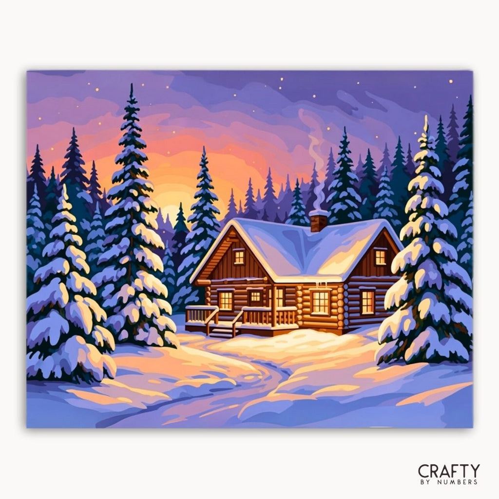 Winter scene with a log cabin surrounded by snow-covered trees at sunset.