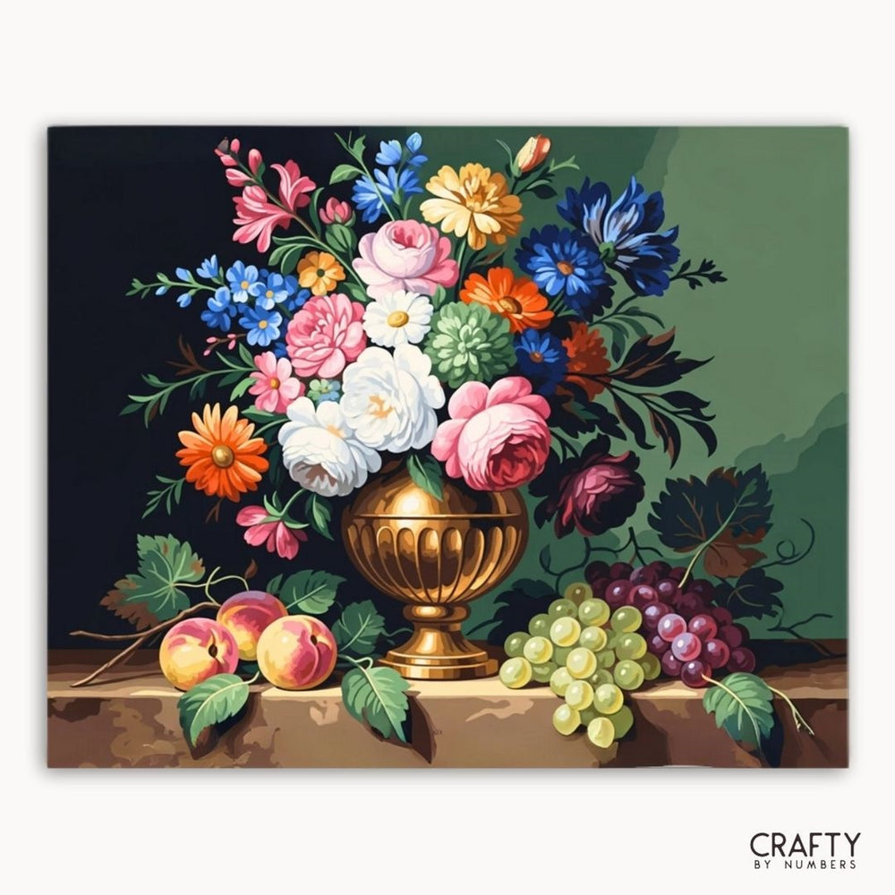 Floral arrangement in a gold urn with fruits on a dark background, featuring the brand 'Crafty by Numbers'.