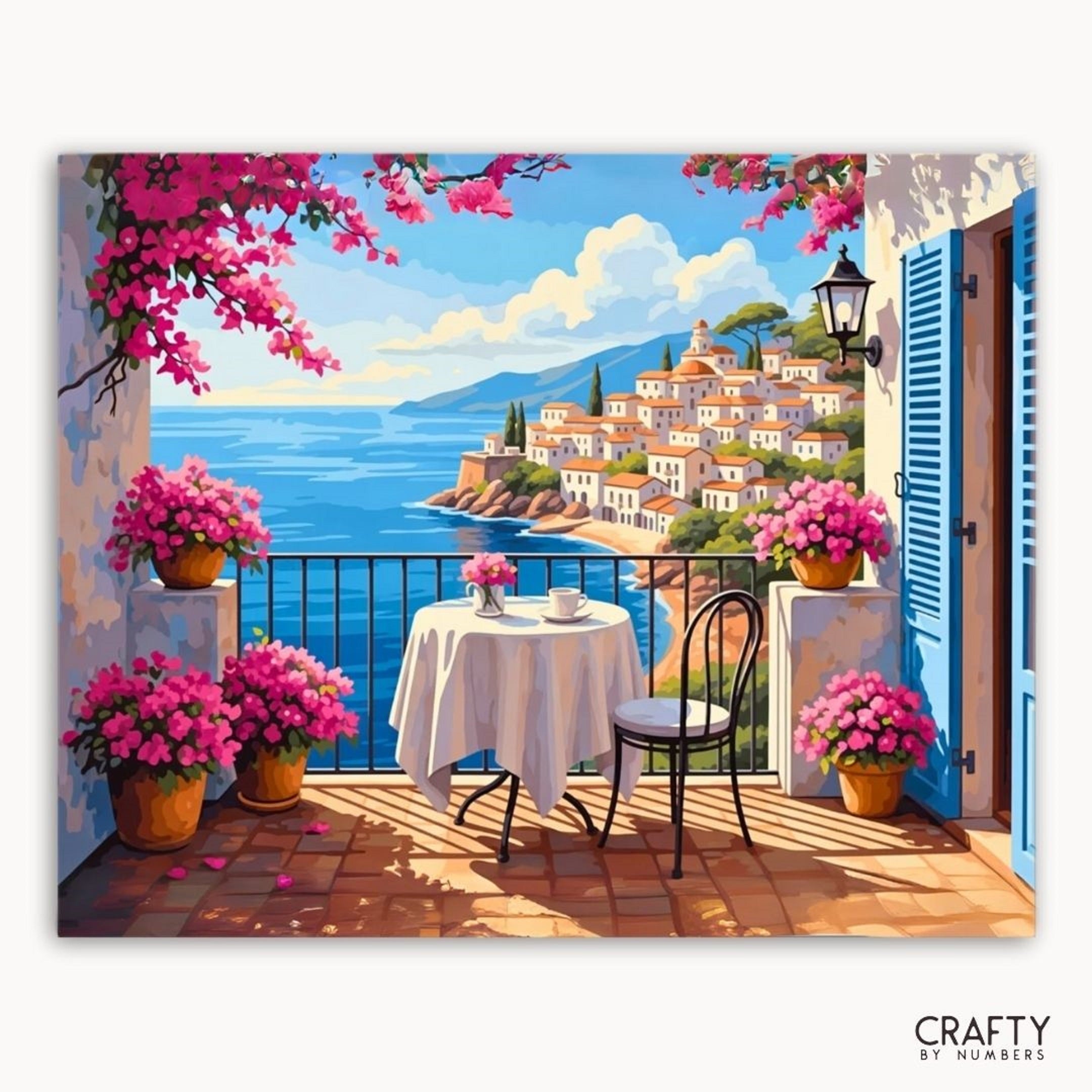 Painting of a coastal scene with a table and chairs on a balcony, surrounded by pink flowers.