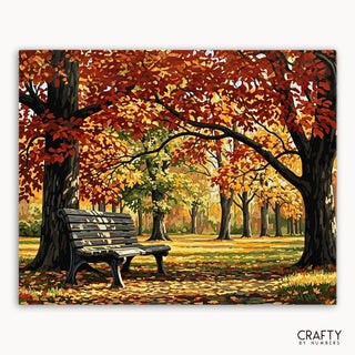 Pintura de un banco bajo árboles otoñales con la marca 'Crafty by Numbers'.