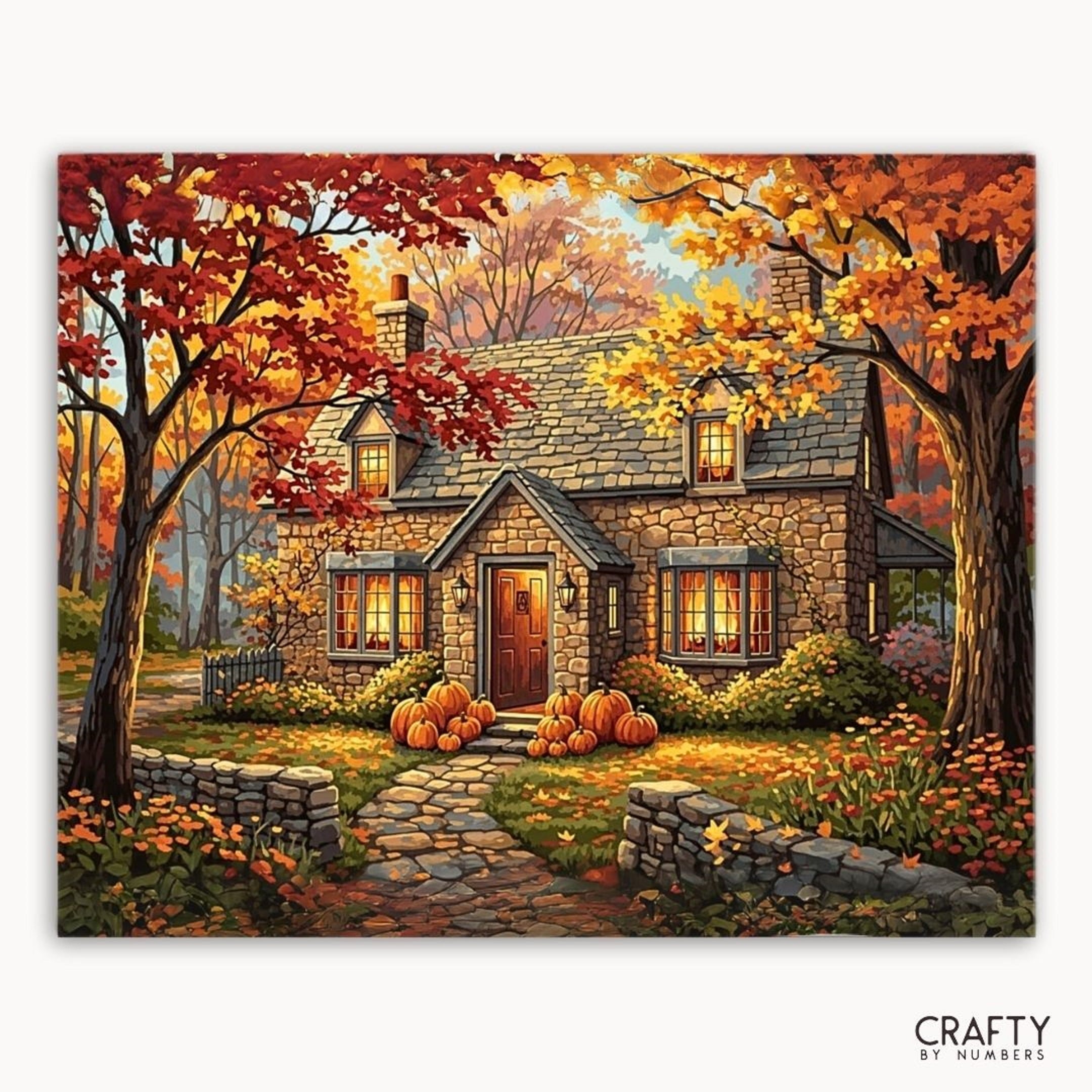 Painting of a cozy stone house with pumpkins in an autumn setting, featuring the brand 'Crafty by Numbers'.