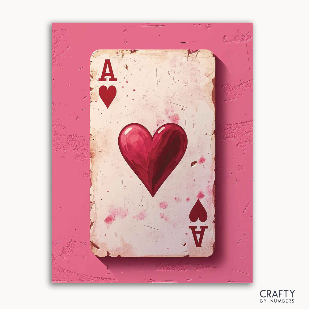 A paint-by-numbers kit image featuring a vintage style depiction of the Ace of Hearts playing card with a pink background, artistic splashes and a heart symbol.