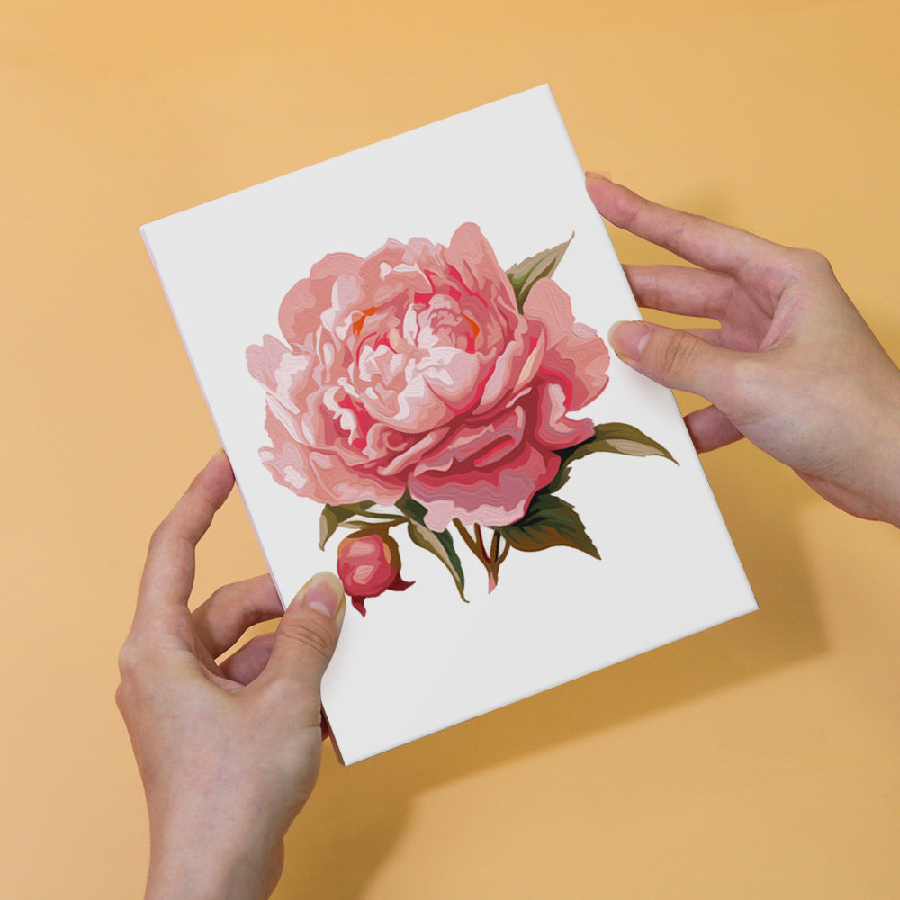 Vibrant paint colors arranged next to a mini flower painting kit